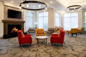 a lobby with chairs and a fire place at Hilton Garden Inn Folsom in Folsom