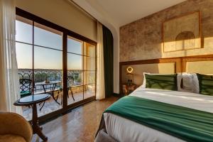 a bedroom with a bed and a large window at Bratus Hotel in Aqaba +169 photos