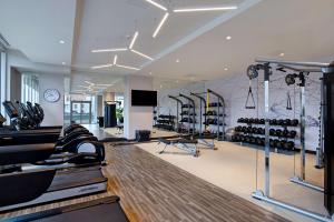a gym with a lot of treadmills and ellipticals at Hampton Inn Montreal Downtown, Qc in Montreal