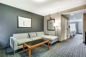 a living room with a couch and a table at Hilton Garden Inn Louisville Airport in Louisville