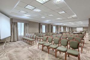 a conference room with chairs and a projection screen at Hilton Garden Inn Springfield, MA in Springfield