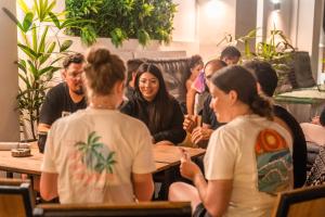 a group of people sitting around a table at Ocean Nomads Coworking in Arona