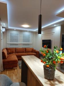 a living room with a couch and a table at Apartment Mb lux 2 in Bijeljina +4 photos