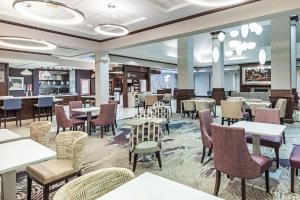 a dining room with tables and chairs and a cafeteria at Hilton Garden Inn Aiken in Aiken