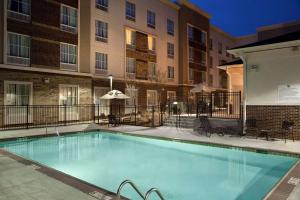 a swimming pool in front of a apartment building at Homewood Suites Charlotte Ayrsley in Charlotte