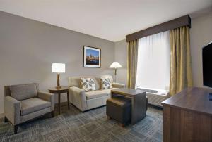 a living room with a couch and a chair at Homewood Suites Charlotte Ayrsley in Charlotte