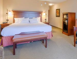 pokój hotelowy z dużym łóżkiem i ławką w obiekcie Hampton Inn & Suites Pinedale w mieście Pinedale