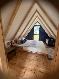 a bedroom with a large bed in an attic at Prima Vista in Žabljak