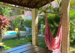 a hammock on the patio of a house at Pousada Cantinho do Sossego in Arraial d'Ajuda