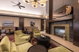 a living room with a fireplace and chairs at Homewood Suites by Hilton Oxnard/Camarillo in Oxnard