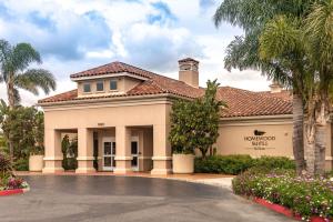 a building with palm trees in front of it at Homewood Suites by Hilton Oxnard/Camarillo in Oxnard