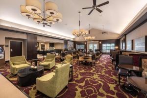 a lobby of a hotel with chairs and tables at Homewood Suites by Hilton Oxnard/Camarillo in Oxnard