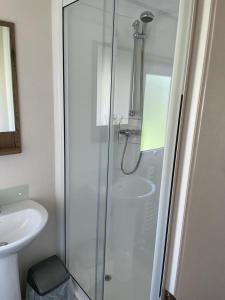 a bathroom with a shower and a sink at luxury caravan in Tattershall