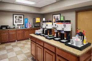 a bar with bottles of wine on a counter at Hampton Inn & Suites Detroit Sterling Heights in Sterling Heights