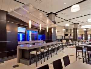 a bar in a restaurant with chairs and tables at DoubleTree by Hilton Lawrenceburg in Lawrenceburg