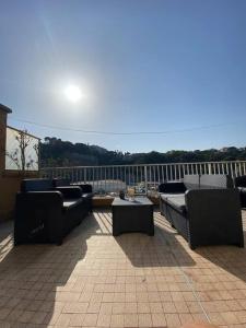 a patio with couches and tables on a balcony at Appartement Nice - Palais des Expositions in Nice
