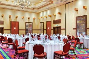 a conference room with tables and chairs and a chandelier at Hilton Santa Fe Buffalo Thunder in Santa Fe