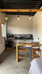 a room with two wooden tables and two chairs at CHALÉS SÃO ROQUE in São Roque