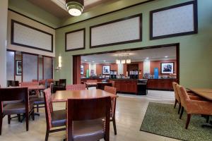 a dining room with tables and chairs and a cafeteria at Hampton Inn & Suites Spartanburg-I-26-Westgate Mall in Spartanburg