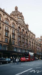 a large building with a christmas tree in front of it at Luxury Knightsbridge apartment outside Harrods in London