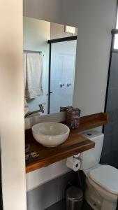 a bathroom with a sink and a toilet at CHALÉS SÃO ROQUE in São Roque