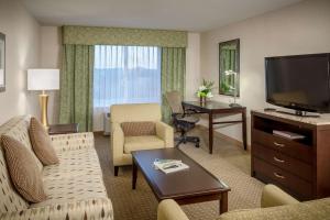 a hotel room with a living area with a television at Hilton Garden Inn Eugene/Springfield in Springfield