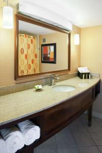a bathroom with a sink and a large mirror at DoubleTree by Hilton Murfreesboro in Murfreesboro