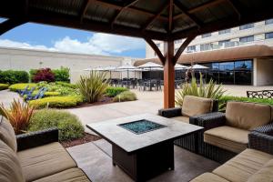a patio with couches and a table and chairs at DoubleTree by Hilton Pleasanton at The Club in Pleasanton
