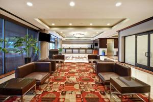 a lobby with leather chairs and a waiting room at DoubleTree by Hilton Pleasanton at The Club in Pleasanton