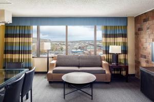 a living room with a couch and a large window at Doubletree By Hilton Billings in Billings