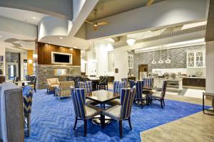 a dining room with tables and chairs and a kitchen at Homewood Suites by Hilton Birmingham Downtown Near UAB in Birmingham
