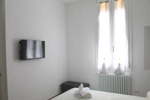 a white room with a table and a window at Appartamento San Vitale in Bologna +3 photos