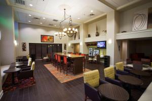 a restaurant with tables and chairs and a dining room at Hampton Inn & Suites Valdosta/Conference Center in Valdosta