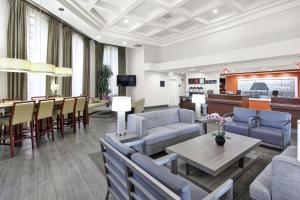 a living room with furniture and a dining room at Hampton Inn & Suites Santa Ana/Orange County Airport in Santa Ana