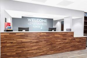 a welcome desk in a dental office with a sign on the wall at Hampton Inn by Hilton Concord/Bow in Concord