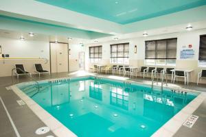 a swimming pool with blue water in a building at Hampton Inn & Suites by Hilton Thunder Bay in Thunder Bay