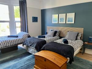 a bedroom with two beds and a window at St Helens House in Portsmouth