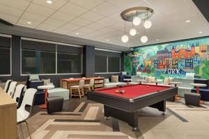 a billiard room with a pool table and a mural at Tru By Hilton York Pa in York
