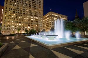 a fountain in the middle of a square with buildings at Embassy Suites Pittsburgh-Downtown in Pittsburgh