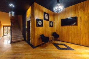 a room with wooden walls and a table and chairs at Royal Plaza Apartment -10A in Tbilisi City