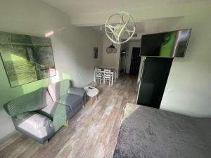 a living room with a couch and a table at Royal Plaza Apartment -10A in Tbilisi City +5 photos