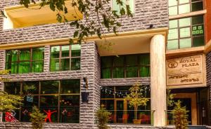 a large brick building with a store front at Royal Plaza Apartment -10A in Tbilisi City