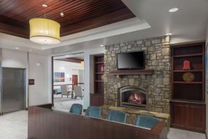 a lobby with a fireplace with chairs and a television at DoubleTree by Hilton Biltmore/Asheville in Asheville
