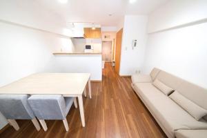 a living room with a table and a couch at Shibuya E Address 303 in Tokyo