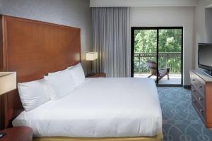 a hotel room with a large bed and a balcony at DoubleTree by Hilton Biltmore/Asheville in Asheville +86 photos
