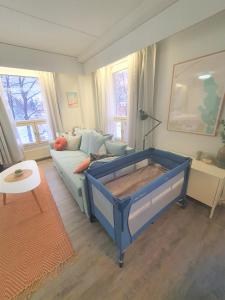 a living room with a blue bed and a couch at City Apartment 302 in Loviisa