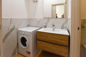 a bathroom with a washing machine and a sink at essegiHome in Porto Empedocle