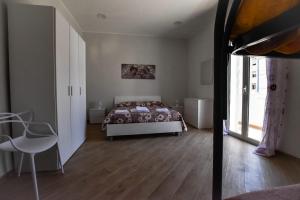 a bedroom with a bed and a table and a chair at essegiHome in Porto Empedocle