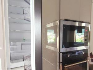a kitchen with a microwave and a refrigerator at Ferienwohnung Werner in Inzell