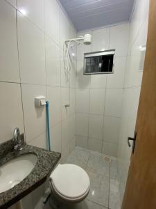 a bathroom with a toilet and a sink at Recanto Sonho - PX Palmas Brasil in Palmas +15 photos